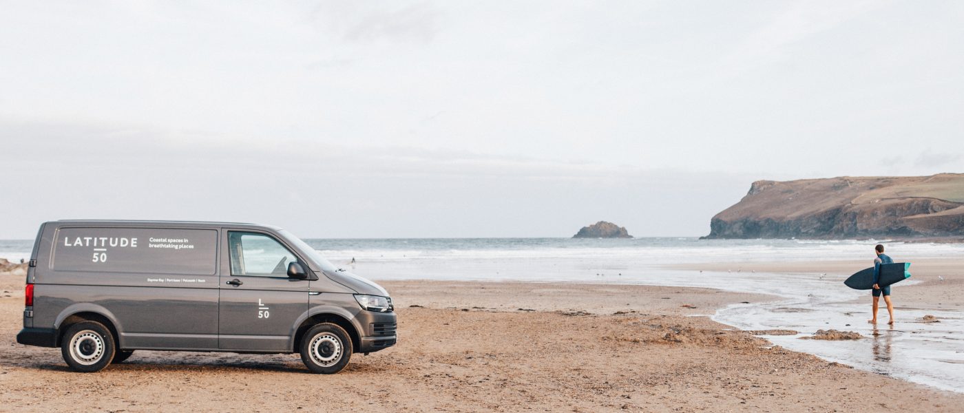 The Latitude50 van and a surfer on Polzeath Beach