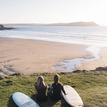 Surfers on the headland at Polzeath