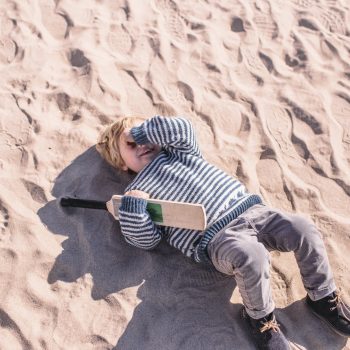Boy with cricket bat on Polzeath Beach