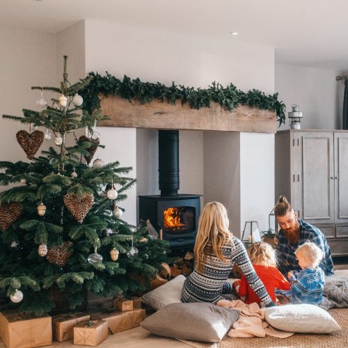 Family around the log burner at Christmas