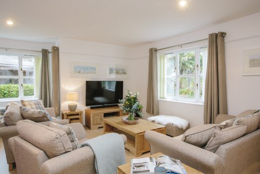 A calming coastal palate and comfortable seating in the living room at 1 Menague in Rock