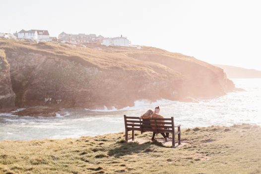 A couple enjoying the view from the headland at Port Gaverne