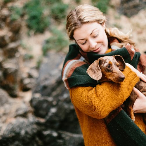 Owner and dog on Rock beach, North Cornwall
