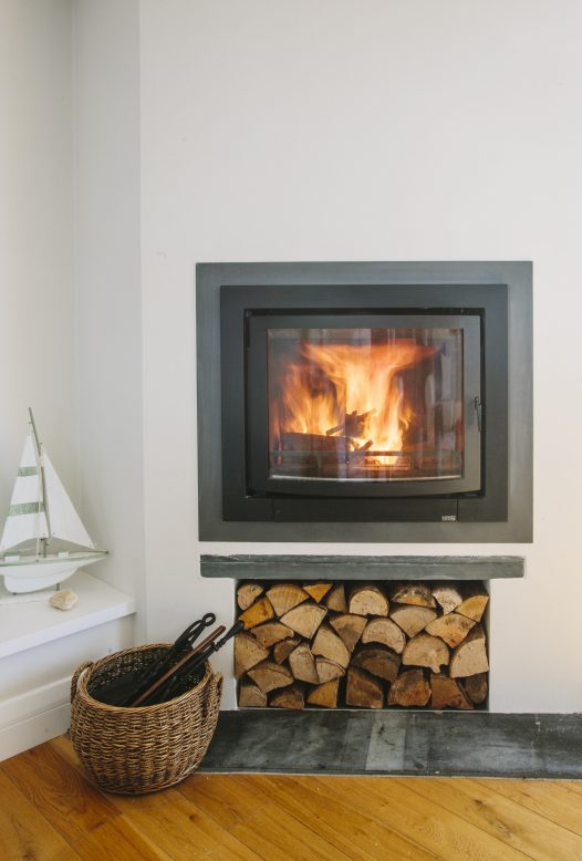 Family around the log burner at Christmas