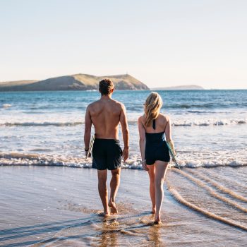 Couple swimming at Polzeath Beach