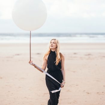 Lady with balloon on Polzeath Beach
