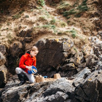 Child making sand castles on Daymer Bay