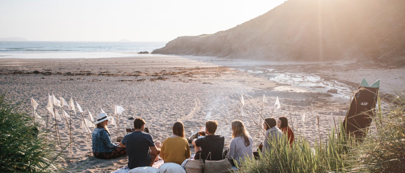 A group enjoying an evening at Baby Bay, Polzeath