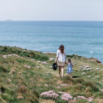Family walking the coastal path above Polzeath Beach