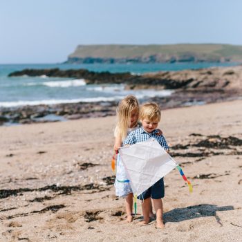 Children playing with a kite on Greenaway Beach