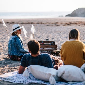 Friends enjoying golden hour at Baby Bay, Polzeath