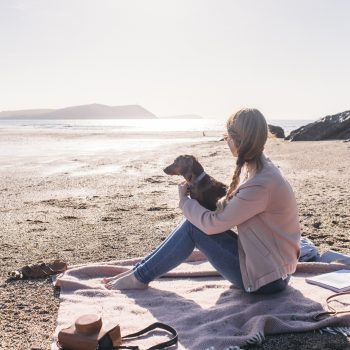 Owner and dog on Polzeath Beach