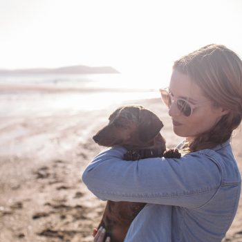 Owner and dog at Polzeath Beach