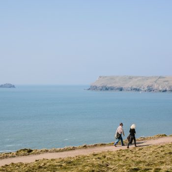 Walkers on the coast path towards Polzeath