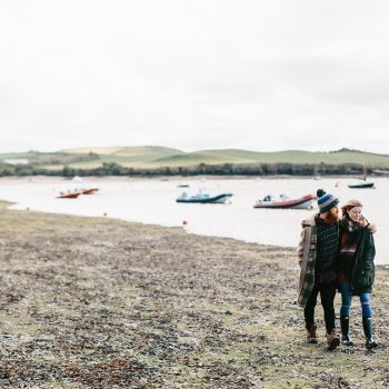Couple enjoying a winter walk on Polzeath Beach