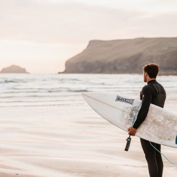 Surfer on the beach at Polzeath, North Cornwall