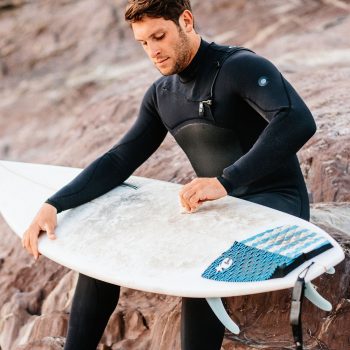 Surfer waxing his board at Polzeath